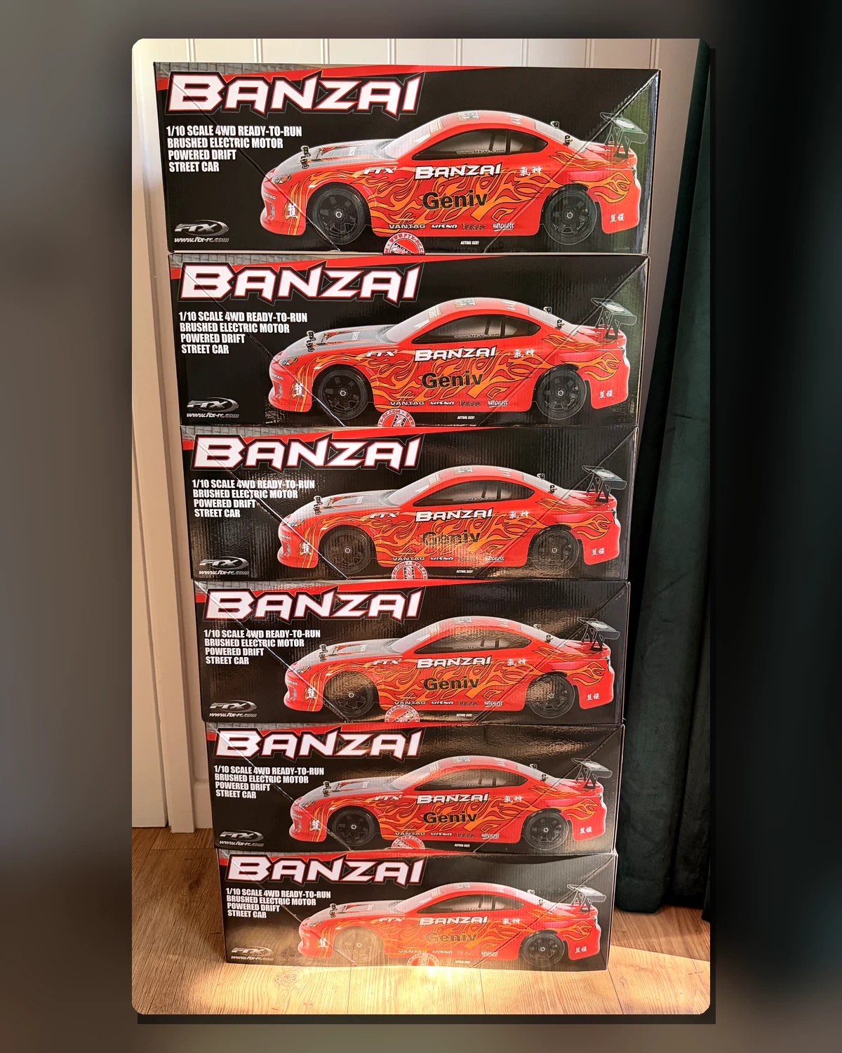 Six boxed FTX Banzai touring cars ready for Next Lap RC Academy